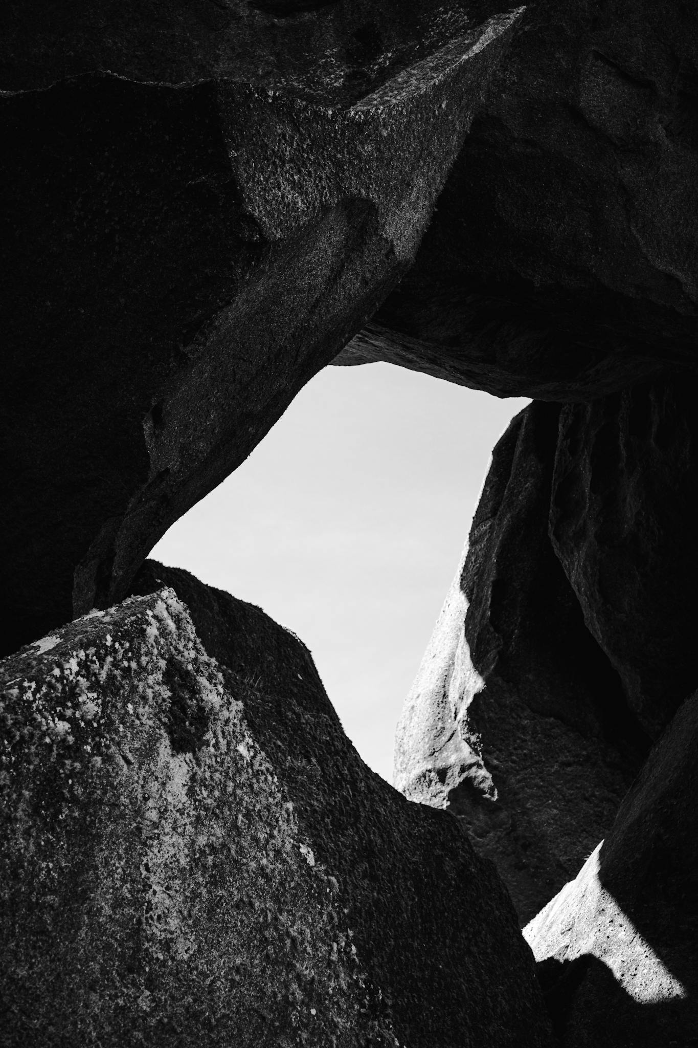 Black and white photo capturing dramatic rock formations in a cave.